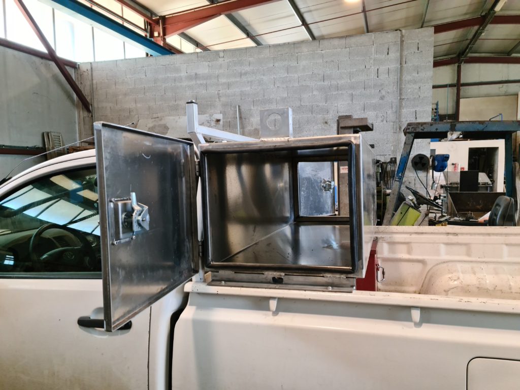 Coffre de pick-up ouvert — vue des compartiments intérieurs.