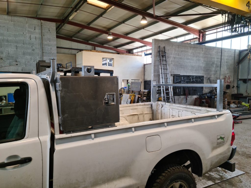 Coffre métallique monté sur la benne d’un pick-up.