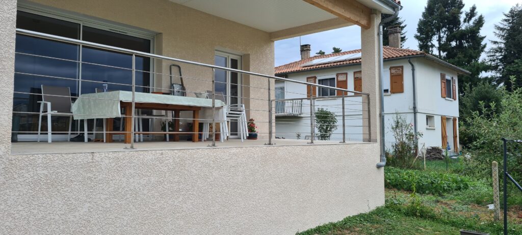 Garde-corps en inox devant une maison — vue d’ensemble.